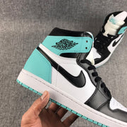 Close-up side view showing the mint green collar panel, winged Jordan branding, and black Swoosh.