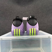 Rear view of purple Nike basketball shoes with black heel details and bright volt outsole accents