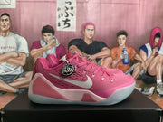 Side profile of a pink Nike basketball sneaker showing the light-colored swoosh, layered midsole panels, and translucent-looking outsole.