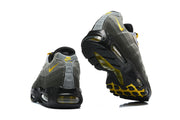 Rear and outsole views of grey Nike Air Max 95 TT sneakers with yellow accents.
