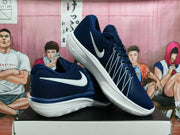 Angled view of navy and white basketball shoes showing their side profiles and lacing