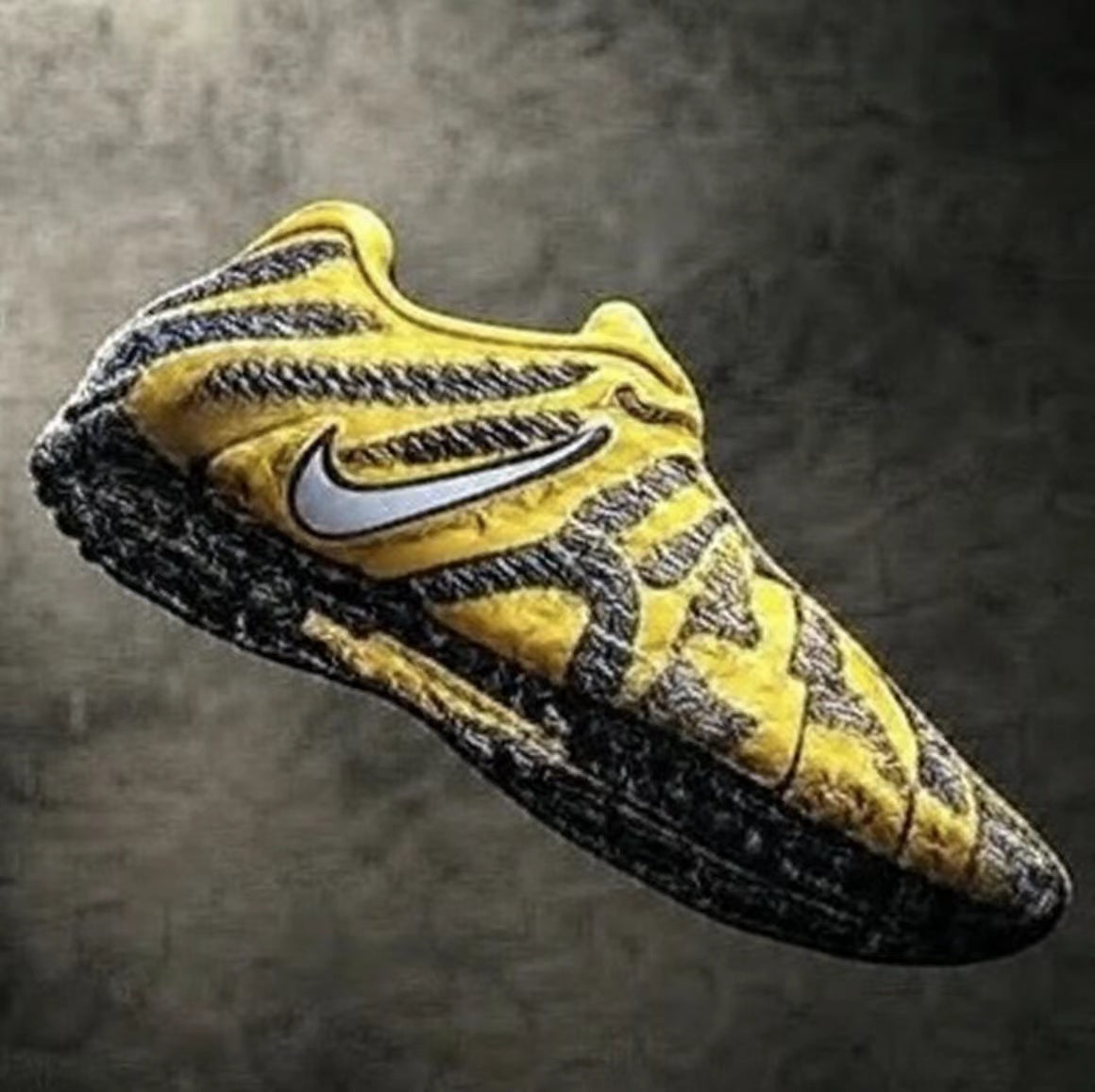 Yellow and black low-top sneaker with a contrasting side logo and black outsole, shown from an angled side view.