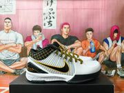 Side profile of a shoe showing gray striped panels, a black Swoosh with gold edging, and a white sole.
