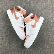 Top-down view of the pair showing the white and rose-gold color blocking.