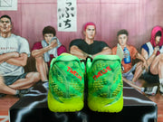 Rear view of the green sneaker pair showing red heel lettering, patterned uppers, and neon green outsoles.