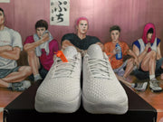 Front view of white Nike basketball sneakers showing the textured uppers, matching laces and tongue details.