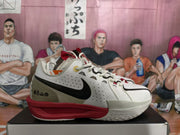 Side profile showing the perforated upper, black Nike Swoosh, gray heel panel, and red midsole.