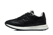Side profile of a black low-top sneaker with tonal logo detailing and a white midsole.