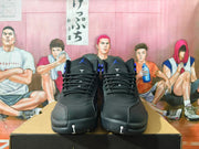Front view of black Jordan high-top sneakers with blue details and lace-up closures.