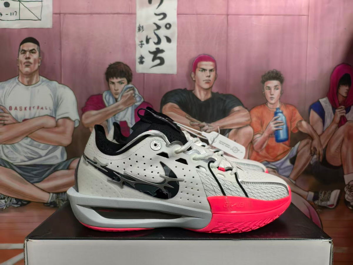 Side view of white Nike Sabrina basketball shoes with black accents and a bright pink outsole.