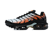 Side view of a black Nike Air Max Plus sneaker with white and orange gradient panels