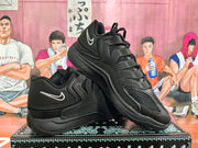 Pair of black low-top Nike sneakers with white Swoosh logos, displayed at an angle