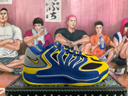 Side view of a royal blue and yellow Nike sneaker with layered blue panels, gray mesh heel, and black mesh inserts.