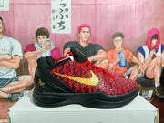 Side profile showing the red patterned upper, gold Nike swoosh, black padded collar, and black sole.