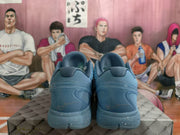 Rear view of the blue basketball sneakers showing sculpted heel sections and signature-style markings.