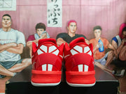 Rear view of red Nike basketball sneakers showing white heel detailing and padded collars.