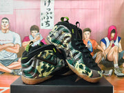Angled view showing the camouflage upper, black side details, and neon accents on the basketball shoes.
