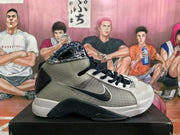 Side view showing the high-top silhouette, black Nike-style side branding, grey upper panels and white midsole.