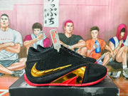 Side view highlighting gold accents and red geometric midsole details.