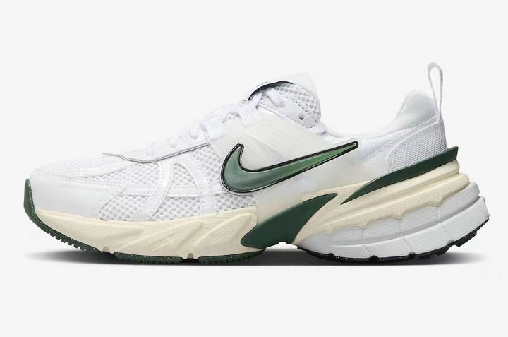 Side view of a white Nike sneaker with dark green accents, mesh panels, and a chunky sculpted sole.