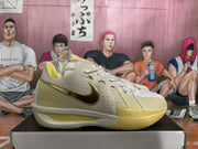 Side profile of a white Nike basketball sneaker with metallic gold Swoosh and translucent yellow outsole