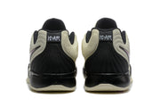 Rear view showing black padded heel sections and cream upper panels