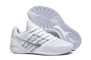 White Nike low-top basketball shoes shown from above and below, with a silver-toned Swoosh.