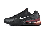 Side view of a black Nike Air Max 720 sneaker with a white Swoosh and translucent red-tinted heel unit.