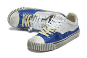 Angled view of the sneakers with contrasting white and cream laces.