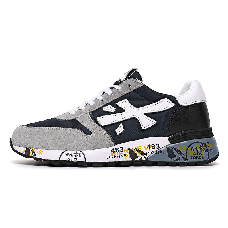 Side view of black and gray low-top sneakers with white laces, a large white side logo, and a printed sole.