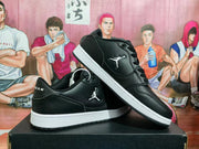 Angled view of the pair displaying the side emblems, black uppers and white midsoles.