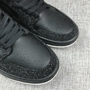 Close-up of the perforated black toe box and speckled toe overlay.