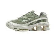 Side view of a sage-green and white Nike Shox Ride 2 sneaker showing mesh panels and sculpted sole.