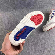 Outsole close-up showing the white tread, red forefoot section, blue midfoot panel, and Jordan branding.