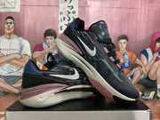 Angled view of the black and white Nike sneakers showing the white Swoosh, textured upper, and contrasting outsole.