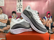 Pair of white, grey, and black sneakers shown from side angles