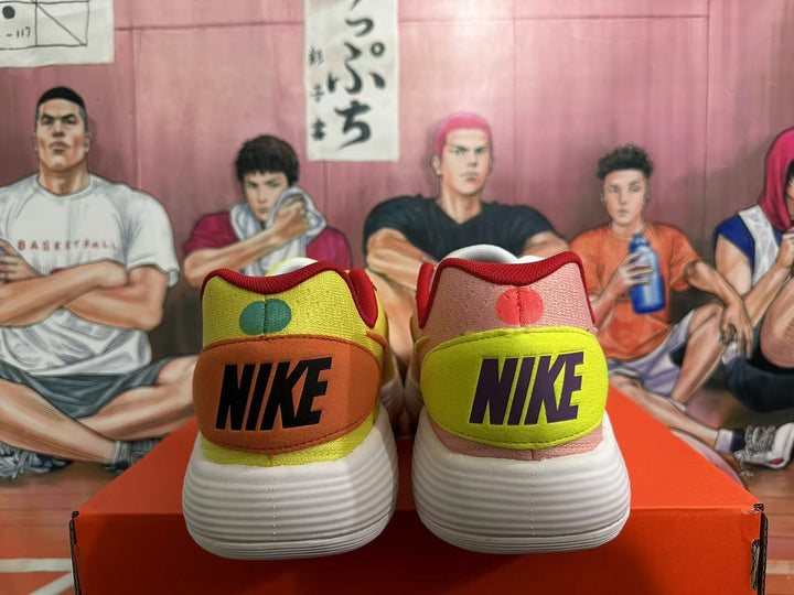 Rear view of the pink and volt-yellow Nike shoes, showing contrasting heel panels and white ridged soles.