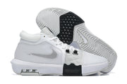 White low-top basketball shoes with black details, shown from the side and outsole.