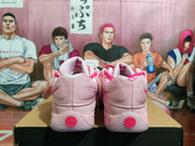 Rear view showing the textured heel panels, small heel Swooshes, and circular pink heel details.