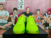 Front view of bright green Nike basketball shoes with textured uppers and Kobe tongue logos.