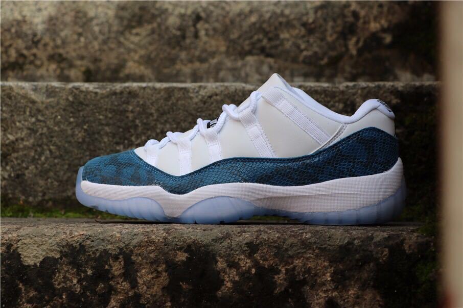 Side view of navy and white Jordan Air Jordan 11 Low sneakers with translucent outsole.
