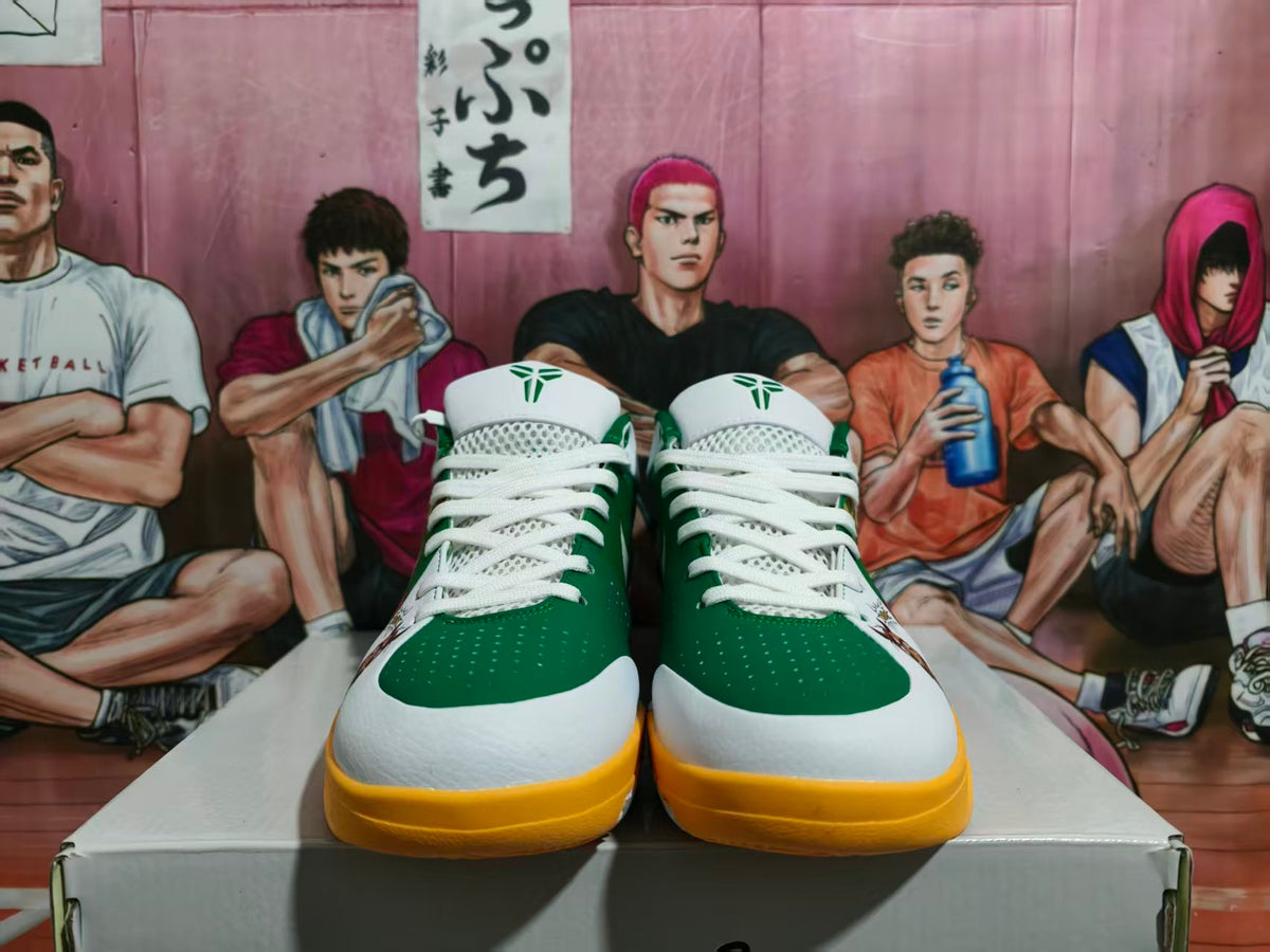 Front view of green, white, and yellow Nike basketball shoes displayed on a shoebox.