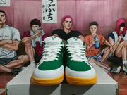 Front view of green, white, and yellow Nike basketball shoes displayed on a shoebox.