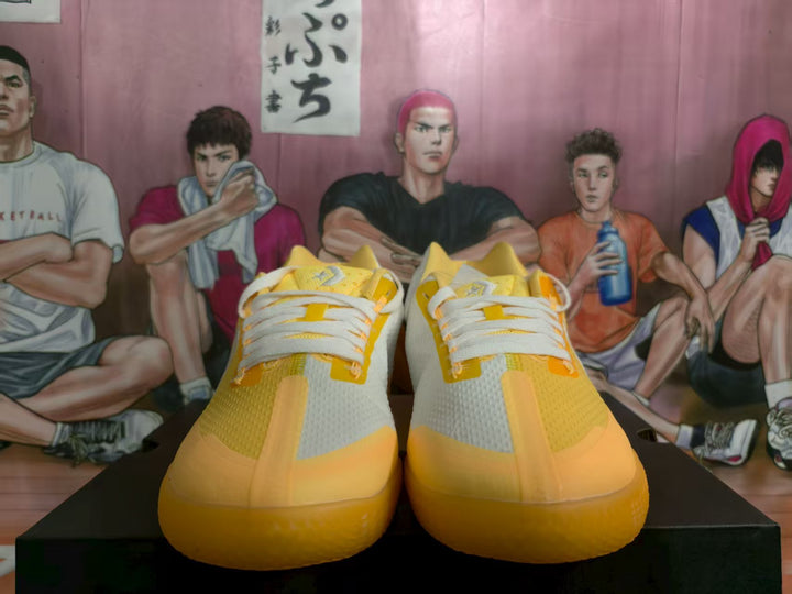 Front view of yellow and white Converse sneakers with white laces and textured uppers.