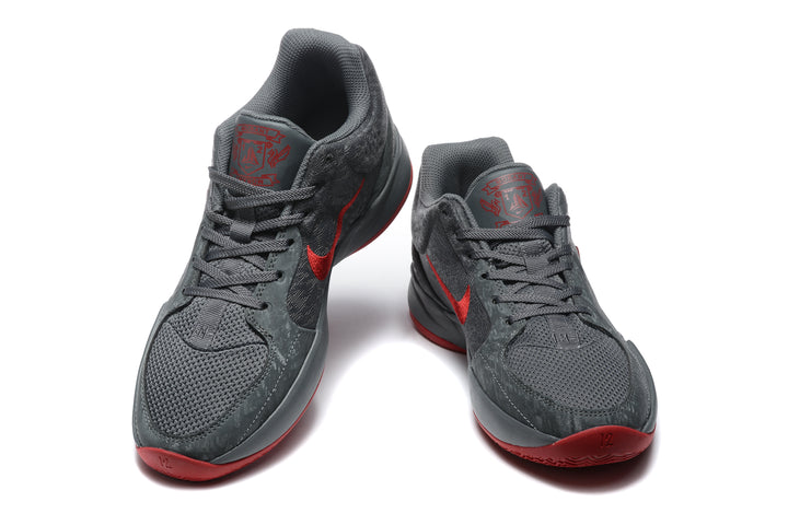 Pair of dark gray and red Jordan 12 low-top sneakers shown from the front.