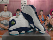 Angled view of two navy and white Jordan basketball sneakers, highlighting the side panels, padded collars, and contrasting outsoles.
