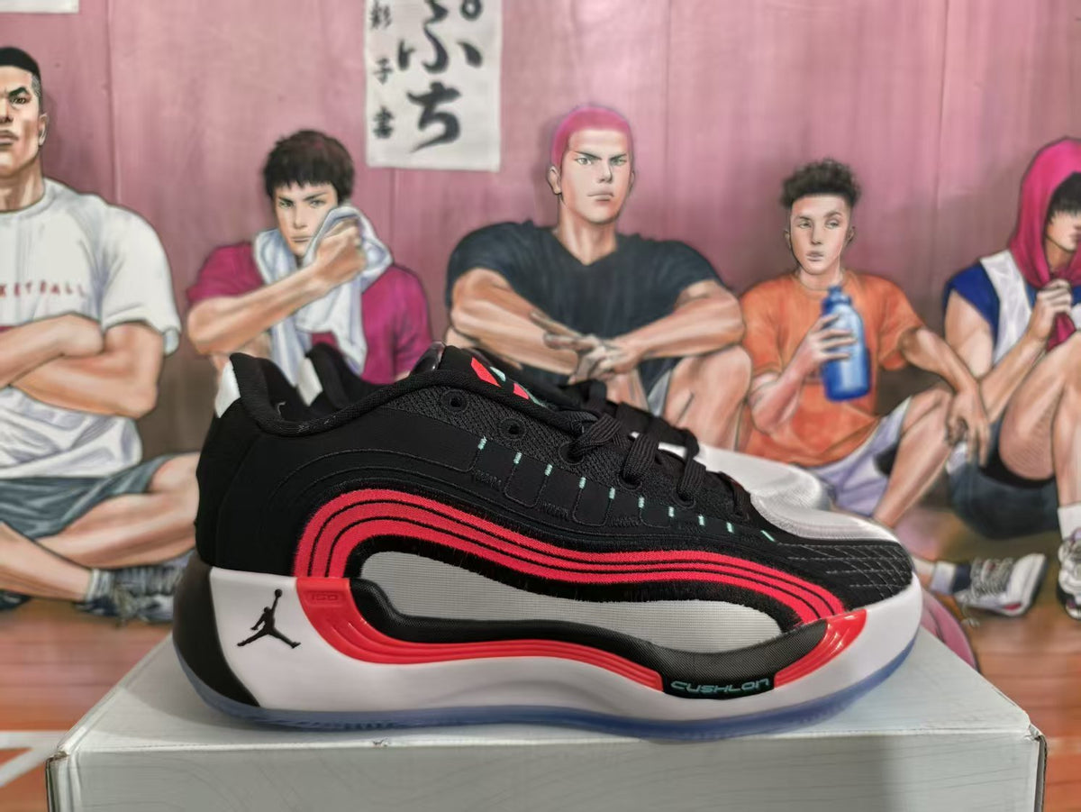 Side view of a black Jordan basketball sneaker with red and white layered details on a shoe box.