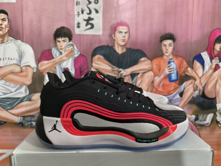 Side view of a black Jordan basketball sneaker with red and white layered details on a shoe box.