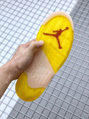 Underside of the sneaker showing a translucent yellow outsole and red Jordan branding.