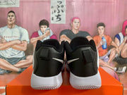 Rear view showing black heel panels, white Swoosh details, white midsoles, and textured outsoles.